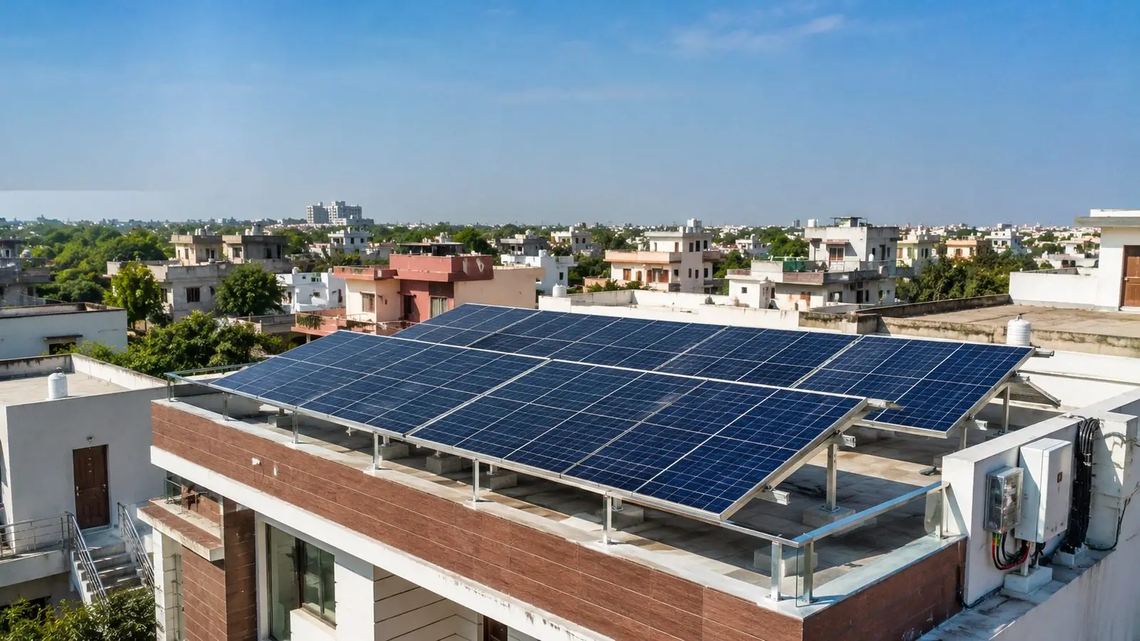 Tilted rooftop solar array on a modern Indian house with a suburban skyline behind, typical of a 10kW residential installation